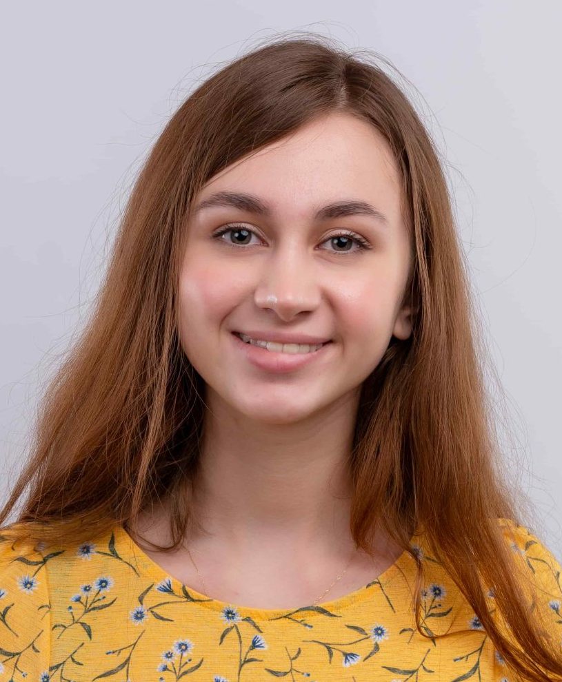 smiling-young-girl-showing-thumbs-up-isolated-white-wall-with-copy-space (1)